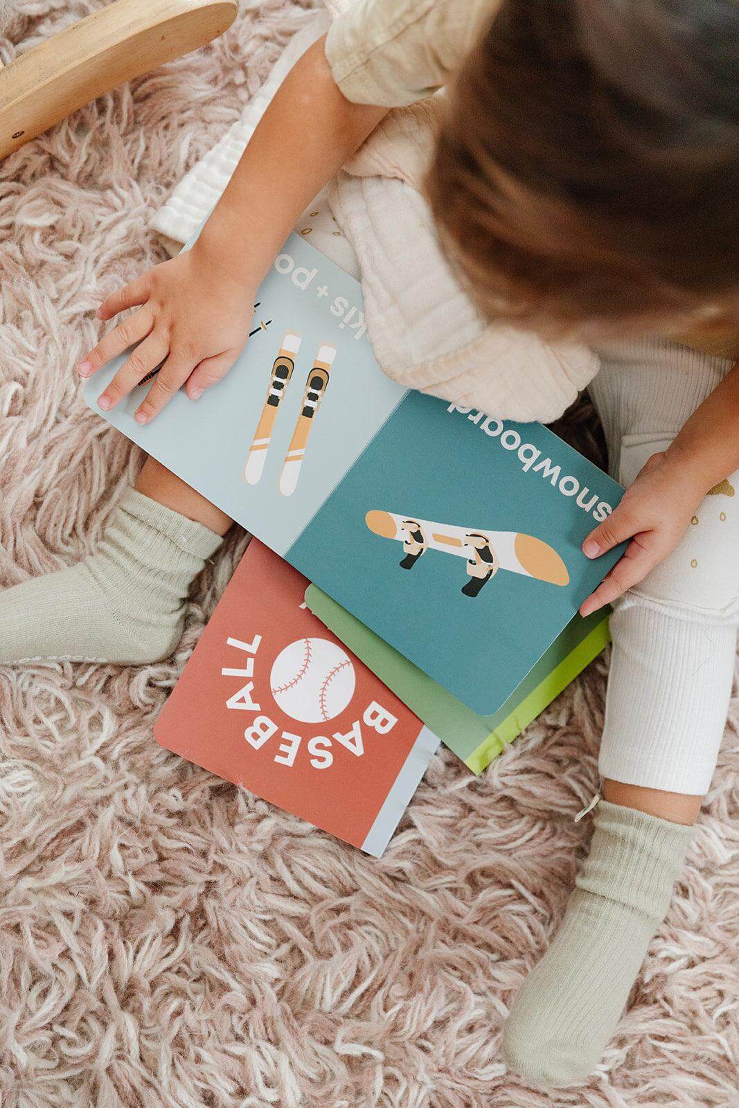 snowboarding baby book, baby snow book, winter sports baby book, baby ski book, toddler snowboard book, sports book for toddlers, sports book for babies, baby board book skiing, modern baby books, cute board books, baby shower gift, nursery decor, baby mountain book  Edit alt text